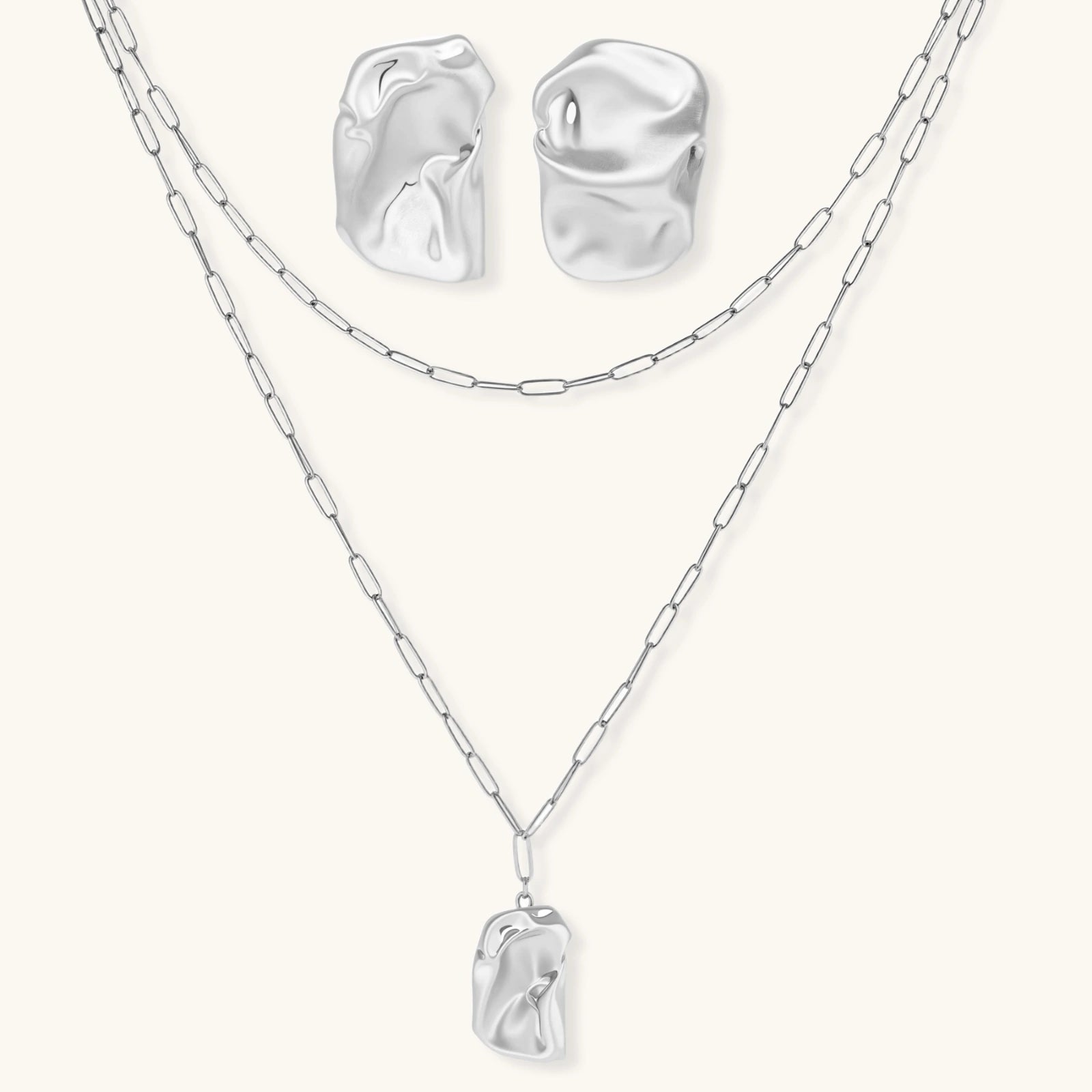 Modern textured hoop earrings and layered chain necklace with liquid metal pendant in silver and gold finishes.